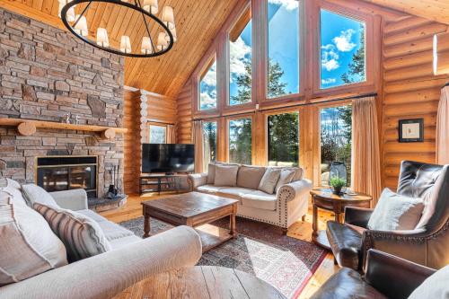 a living room with couches and a fireplace at Fiddler Lake Resort - Deer 86 in Mille-Isles