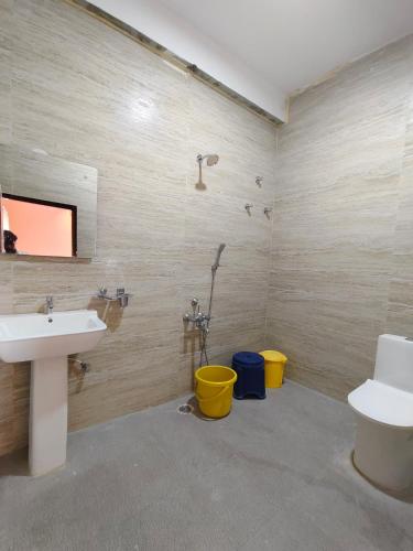 a bathroom with a sink and a toilet at NARGILA HAMPi in Hampi