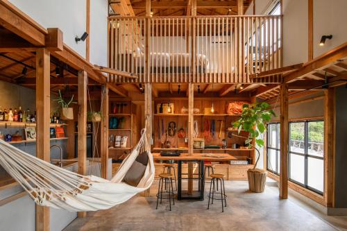 a hammock hanging in a room with a kitchen at TheMana Village in Tosashimizu
