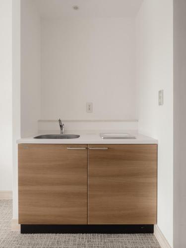a bathroom with a sink and a counter at Anse Yomitan Toya in Yomitan