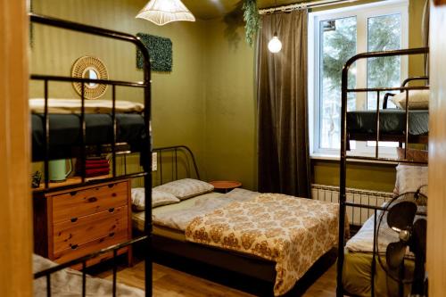 a bedroom with two bunk beds and a window at Kempings Liepene in Liepene