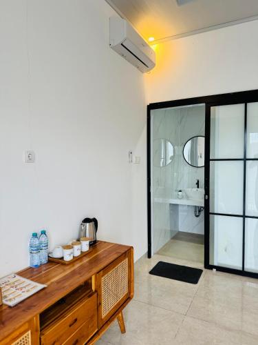 a bathroom with a wooden counter and a glass shower at The Infinity Kintamani With Natural Hot Spring in Kubupenlokan