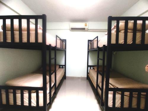 two sets of bunk beds in a room at 55 Hostel Soi Phetkasem 51 in Ban Tambon Bang Khae