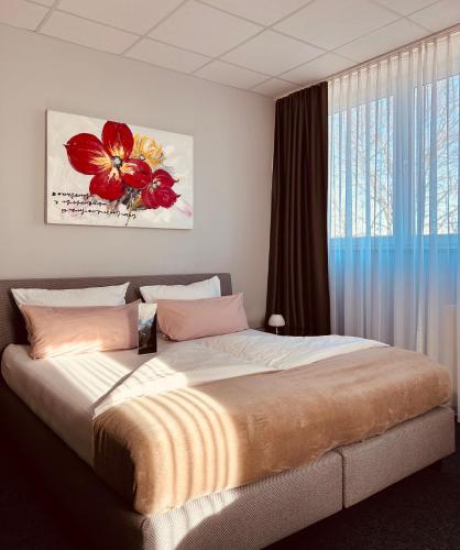 a bedroom with a large bed and a window at Komm' In Hotel in Mechernich
