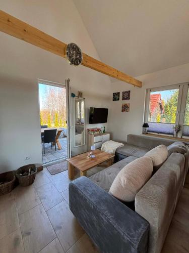 a living room with a couch and a table at Na domek do Pati in Przejma Wielka