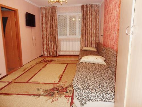 a room with a bed in the corner of a room at Ахметова 10 in Krasnoye Pole