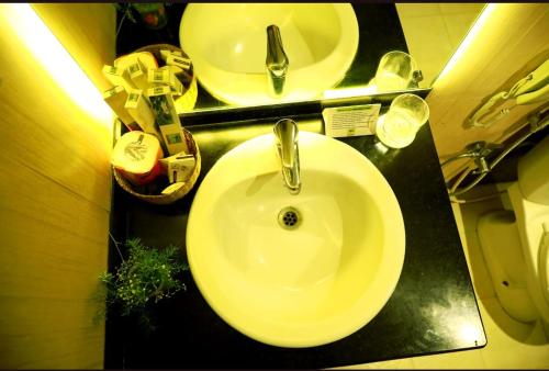 a bathroom with a white sink and a mirror at Paray Village County in Kollengode