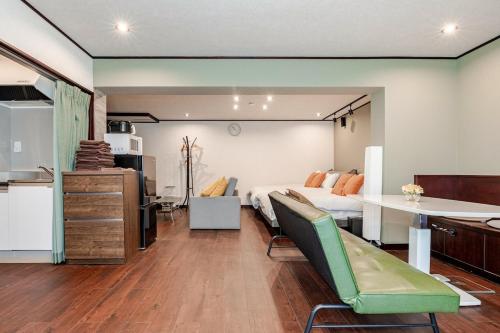 a living room with a bed and a table at Shibuya 10 min Walk Theater & Garden Stay Max 6ppl in Tokyo
