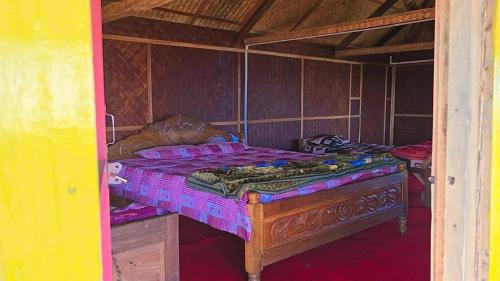 a bedroom with a large bed in a room at Nature's Harmony Heaven in Dāmbuk