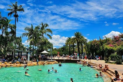 a group of people in a pool at a water park at 2bedrm unit next to southbank in Brisbane