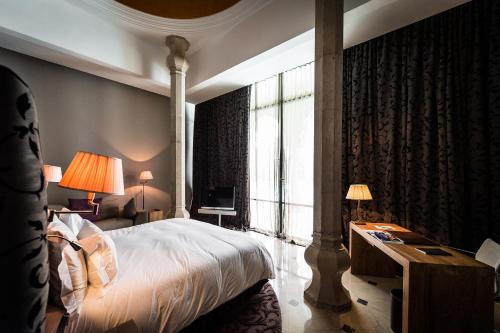 a bedroom with a bed and a large window at Palais Namaskar in Marrakech