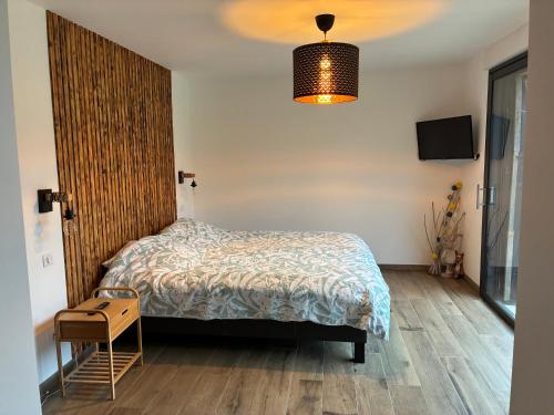 a bedroom with a bed and a wooden floor at Aloha House 88 in Le Val-dʼAjol