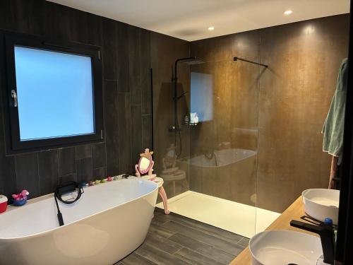 a bathroom with a tub and a shower and a sink at Aloha House 88 in Le Val-dʼAjol