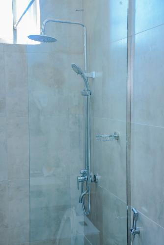 a shower with a glass door in a bathroom at The Residence Hotel Dodoma in Dodoma