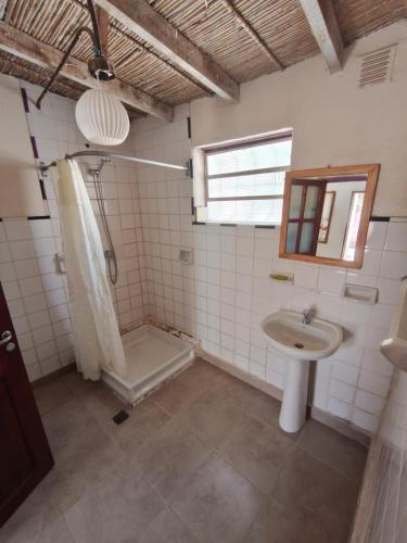 a bathroom with a shower and a sink at Posada Las Piedras in Tilcara