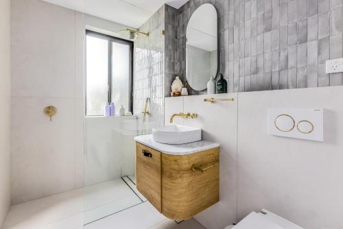 a bathroom with a sink and a mirror at Medusa Bondi in Sydney