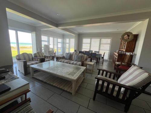 a living room with couches and a table at 87 Marine Drive in Struisbaai