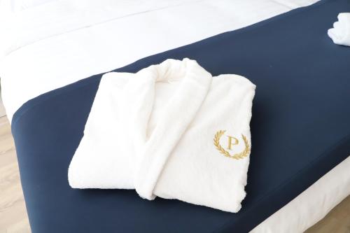 a pair of towels sitting on top of a bed at Podium Boutique Hotel in Yerevan