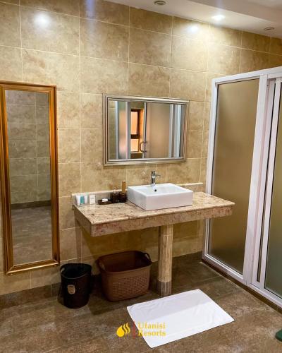 a bathroom with a sink and a mirror at Ufanisi Resort - Kisii in Kisii
