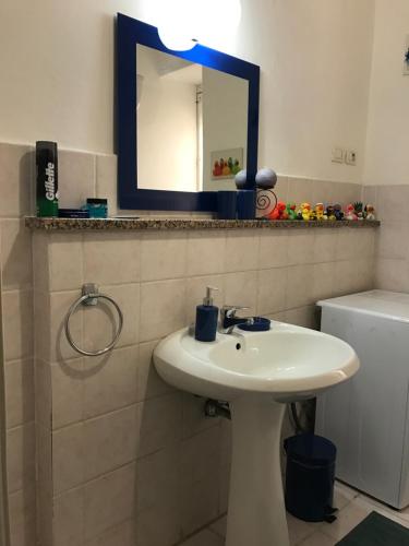a bathroom with a sink and a mirror on the wall at B&B In Centro in Cagliari