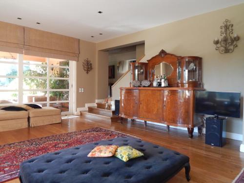 a living room with a tv and a couch at Slow living beautiful villa in Rafina