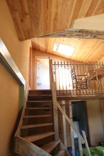 a staircase in a house with wooden ceilings at Lu Stâve in Stoumont