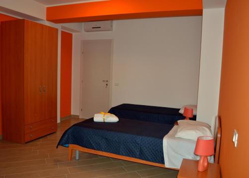 a bedroom with a bed and a wooden cabinet at B&B Federico II in San Cipirello