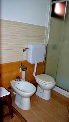 a bathroom with a toilet and a sink at B&B Federico II in San Cipirello