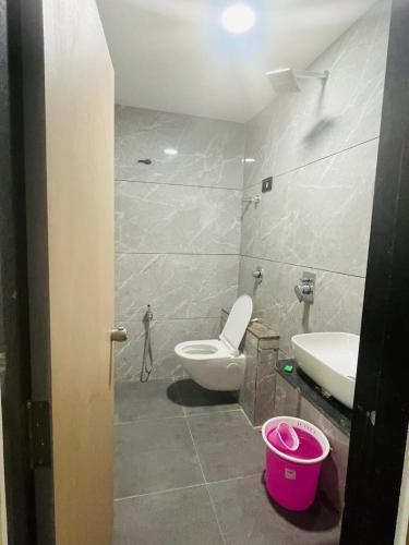 a bathroom with a toilet and a sink at Hotel hills in Ahmedabad