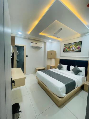 a bedroom with a large bed in a room at Hotel hills in Ahmedabad