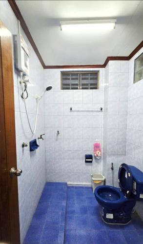 a bathroom with a blue toilet and a shower at 57 hua hin in Hua Hin