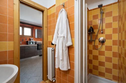 a bathroom with a white towel hanging on a wall at Bella Vita Stays Relax in Sondrio