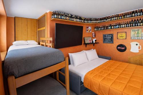 a small room with two beds and a chalkboard at Bella Vita Stays Relax in Sondrio