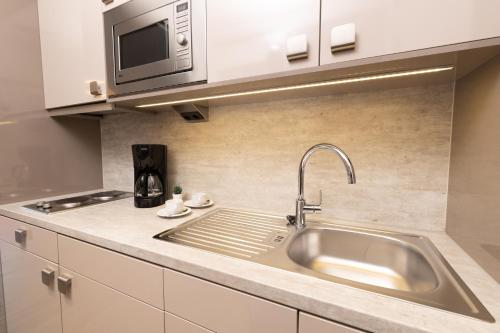 a kitchen with a sink and a microwave at east Apart in Erlangen