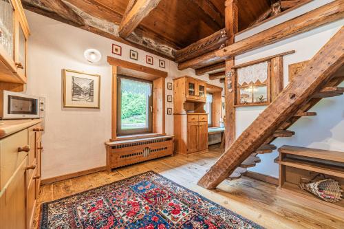 a living room with a staircase in a cabin at Da La Auri in Canale dʼAgordo