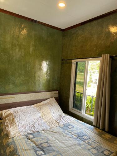 a bedroom with a bed and a window at Turtle beach Bar 1 Bedroom in Thai Muang