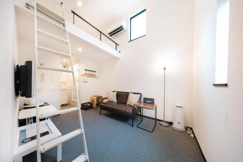 a living room with a loft bed and a couch at Apartment Sanjo in Nara