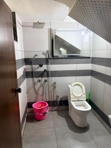 a bathroom with a shower and a toilet and a sink at Winter Heaven in Cochin