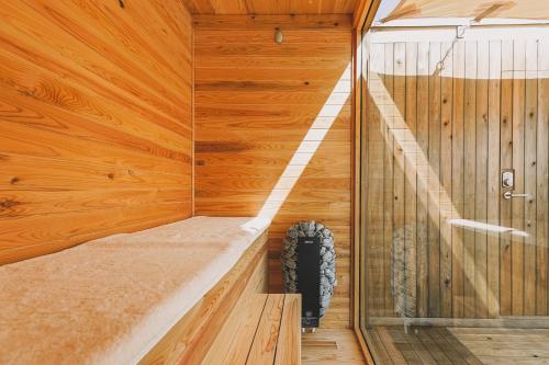 a sauna with a tire sitting in a wooden wall at Earthboat Saitama Kawajima in Kawagoe