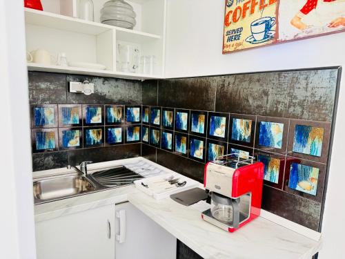 a kitchen with a counter with a red appliance on it at Villa Sila in Novalja