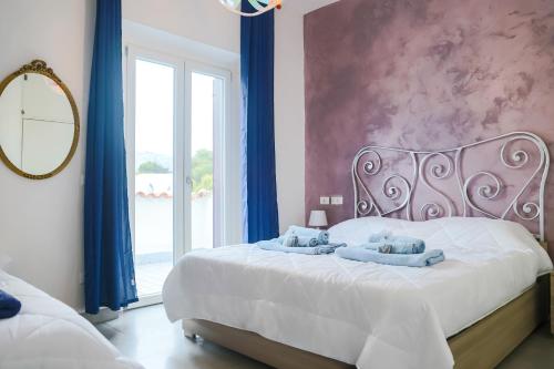 a bedroom with a bed with blue towels on it at Villa Penelope in Terracina