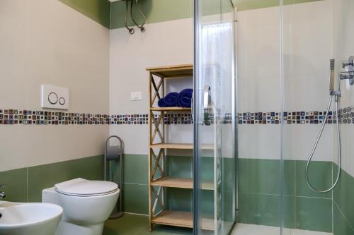 a bathroom with a shower and a toilet and a sink at Villa Penelope in Terracina