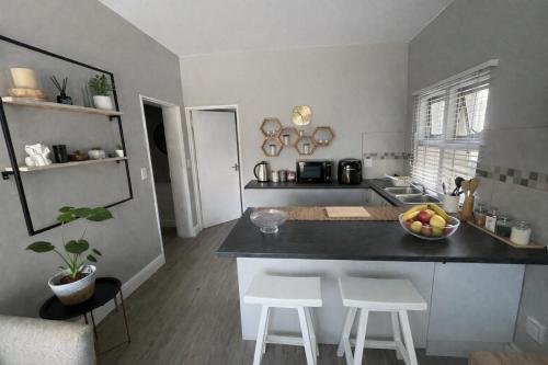 a kitchen with a counter with a bowl of fruit on it at Tijger Haven in Tygerberg Hills