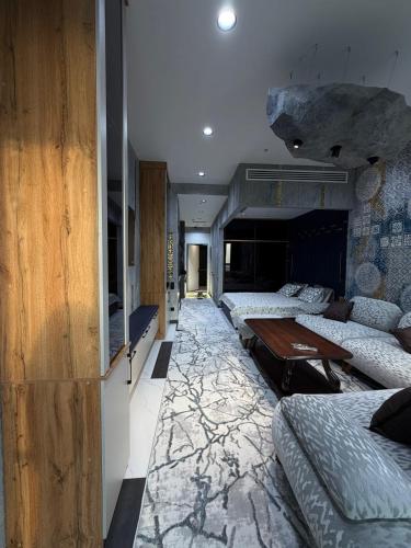 a room with several beds and a table in it at NEST ONE - Floor 15 in Tashkent