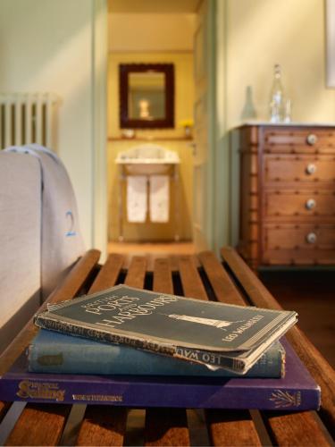 two books sitting on top of a wooden table at Hotel Tresanton in Saint Mawes