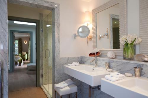 a bathroom with two sinks and a mirror at Hotel Tresanton in Saint Mawes