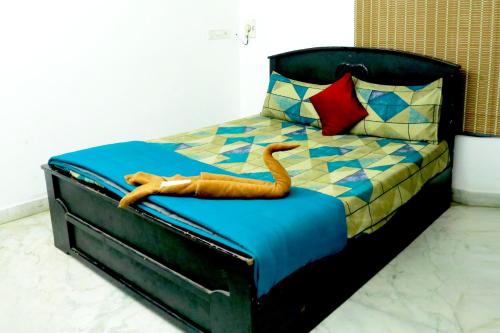 a bed with a toy snake laying on it at ECR Holiday in Chennai