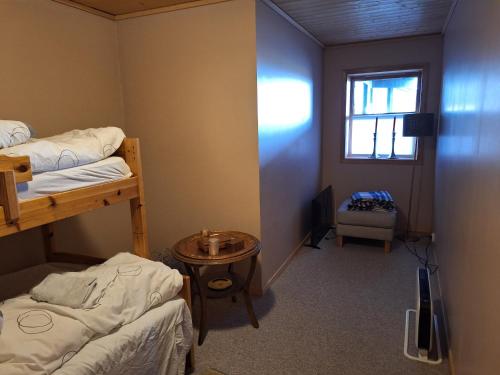 a room with two bunk beds and a window at Slettavegen1a in Time