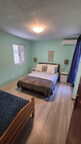 a bedroom with a large bed in a room at Apartment Bunjo's Beach House in Trogir