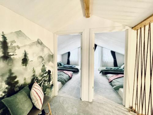 a room with two mirrors in a room with beds at Cranberry Cabin Buscat in Muntele Băişorii